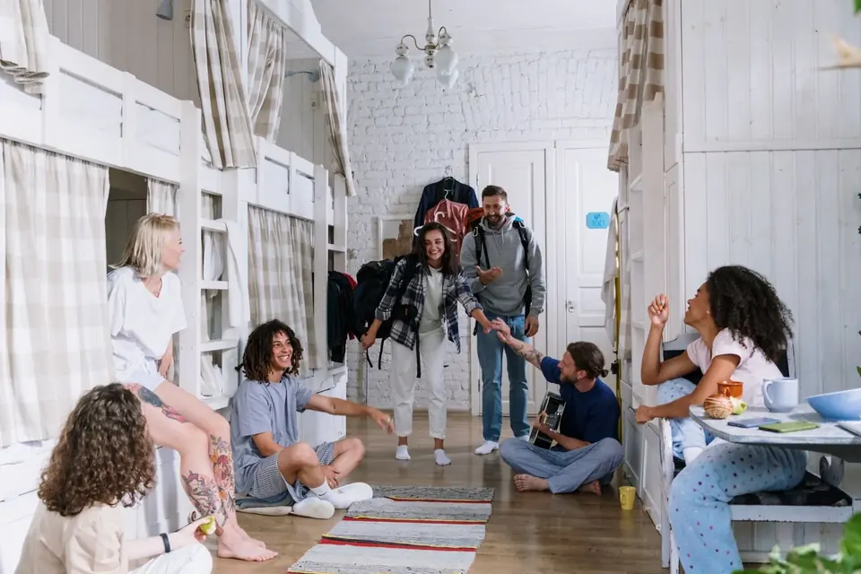 Students hanging out together in a college dorm room on move-in day